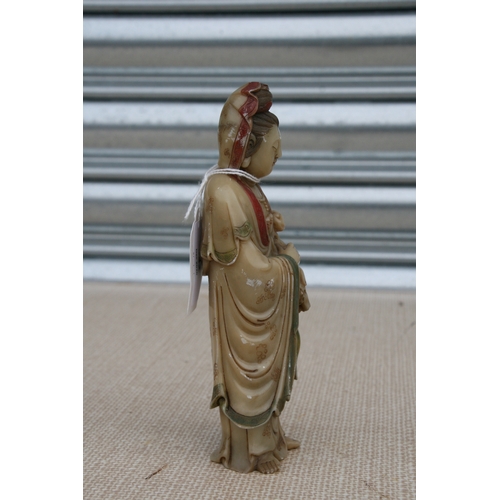 532 - An 18th / 19th century Chinese polychrome soapstone carving depicting Guanyin, 17cms (6.75ins) high.