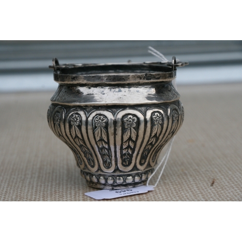 949 - An Italian embossed silver Holy Water bucket with swing handle, overall 13cms (5ins) high.