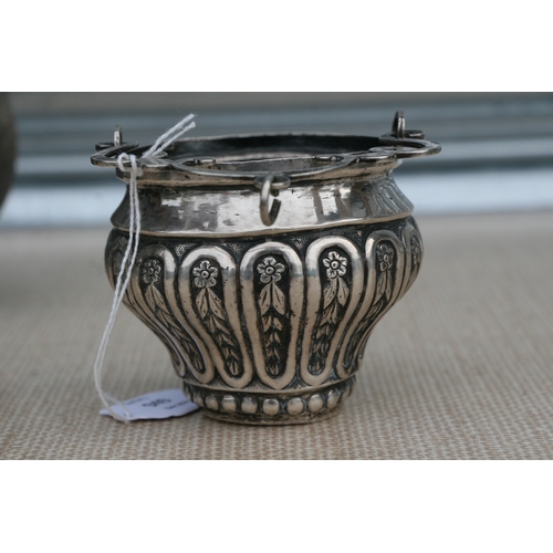 949 - An Italian embossed silver Holy Water bucket with swing handle, overall 13cms (5ins) high.