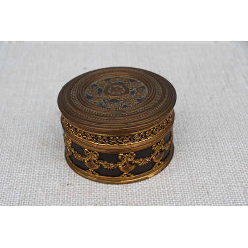 595 - A French gilt metal dressing table box, 11cms (4.75ins) diameter.