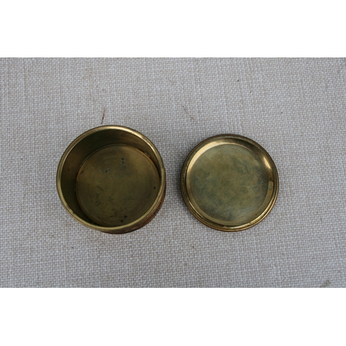 595 - A French gilt metal dressing table box, 11cms (4.75ins) diameter.