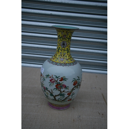 557 - A Chinese Republic famille rose vase decorated with pomegranates, red seal mark to the underside, 33... 