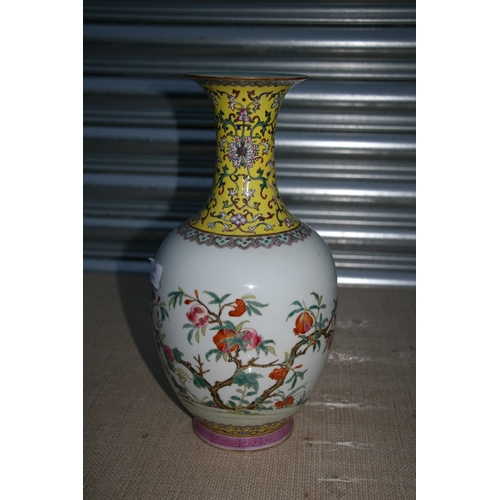 557 - A Chinese Republic famille rose vase decorated with pomegranates, red seal mark to the underside, 33... 