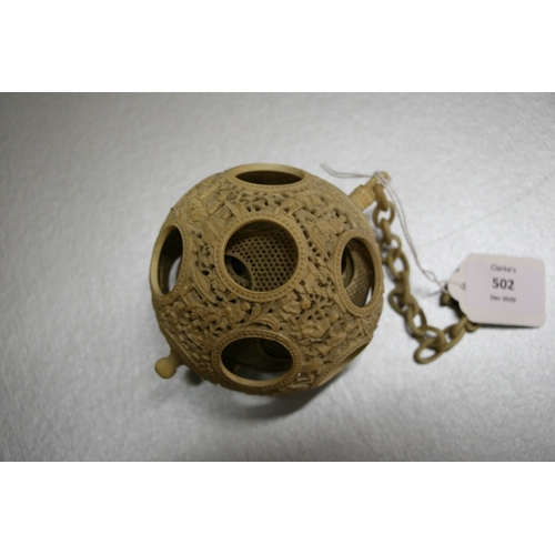 502 - A 19th century Chinese ivory hanging puzzle ball decorated with figures in a landscape, 10cms 94ins)... 