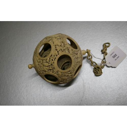 502 - A 19th century Chinese ivory hanging puzzle ball decorated with figures in a landscape, 10cms 94ins)... 