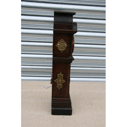 123 - A 19th century style oak miniature longcase clock, the hood and trunk with applied brass decoration,... 