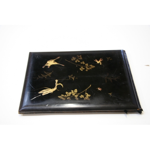 441 - A late 19th century Japanese Meiji period lacquered album cover, the interior with marbled boards an... 