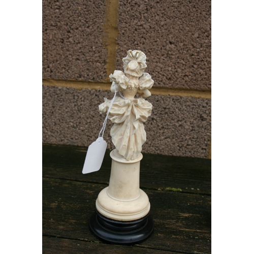 559 - A 19th century Dieppe ivory figure in the form of a young lady holding a parasol, overall 23cms (9in... 