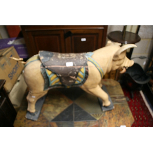 638 - A carved and painted wooden carousel figure in the form of a pig, 80cms (31.5ins) wide.