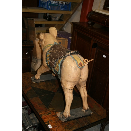 638 - A carved and painted wooden carousel figure in the form of a pig, 80cms (31.5ins) wide.