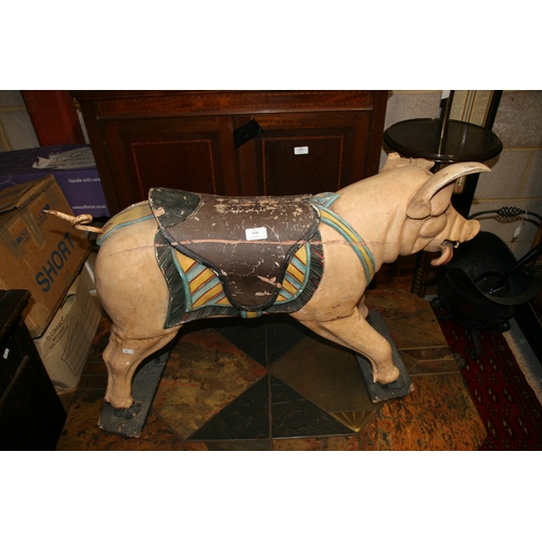 638 - A carved and painted wooden carousel figure in the form of a pig, 80cms (31.5ins) wide.