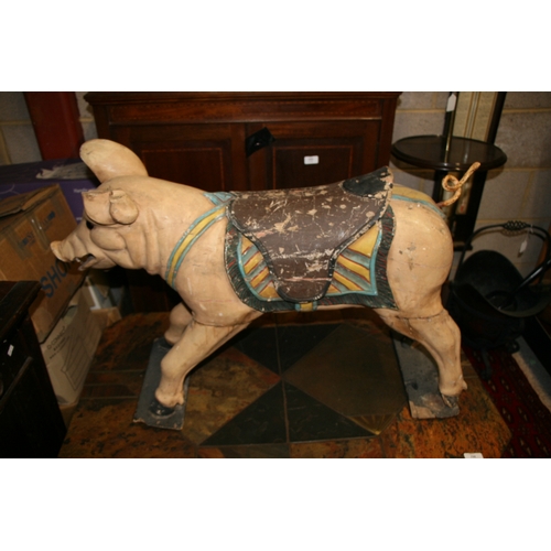 638 - A carved and painted wooden carousel figure in the form of a pig, 80cms (31.5ins) wide.