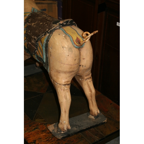 638 - A carved and painted wooden carousel figure in the form of a pig, 80cms (31.5ins) wide.