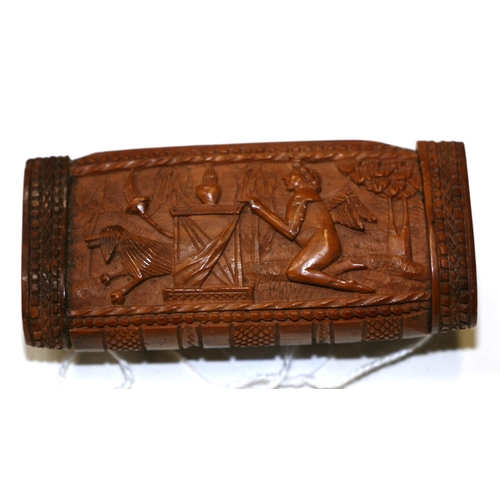 601 - A 19th century coquilla nut snuff box, finely carved with Cupid, 7.5cms (3ins) wide.