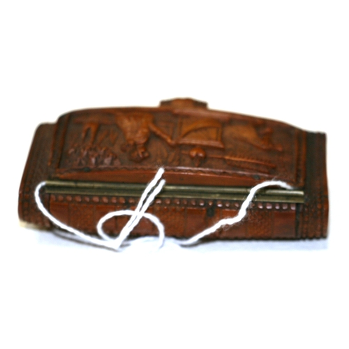 601 - A 19th century coquilla nut snuff box, finely carved with Cupid, 7.5cms (3ins) wide.