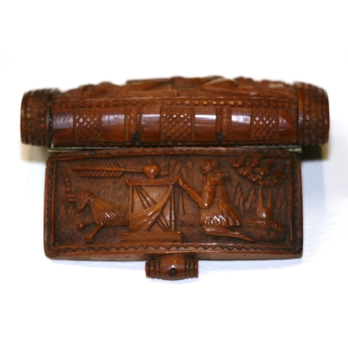 601 - A 19th century coquilla nut snuff box, finely carved with Cupid, 7.5cms (3ins) wide.