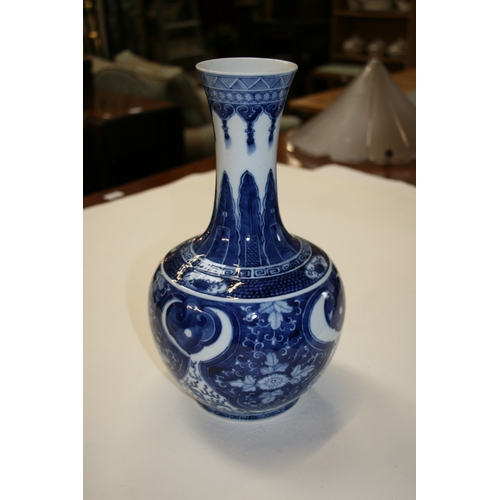 380 - A large Chinese blue & white vase decorated with flowers and dragons, four character blue mark to th... 