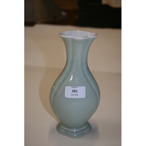 381 - A Chinese pale celadon glazed vase with blue seal mark to the underside, 20cms (8ins) high.