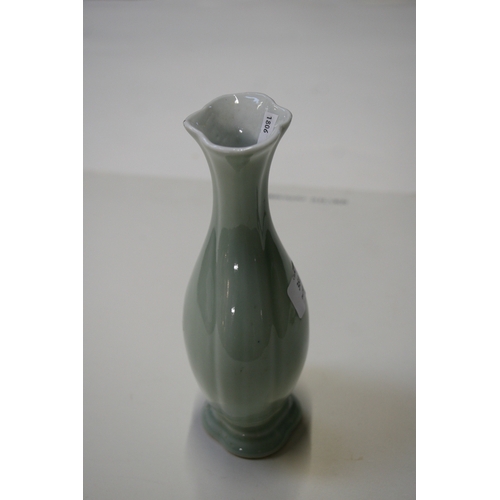 381 - A Chinese pale celadon glazed vase with blue seal mark to the underside, 20cms (8ins) high.