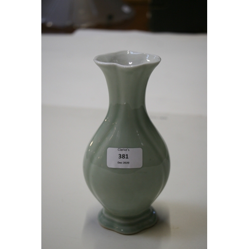 381 - A Chinese pale celadon glazed vase with blue seal mark to the underside, 20cms (8ins) high.