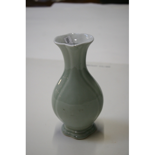 381 - A Chinese pale celadon glazed vase with blue seal mark to the underside, 20cms (8ins) high.