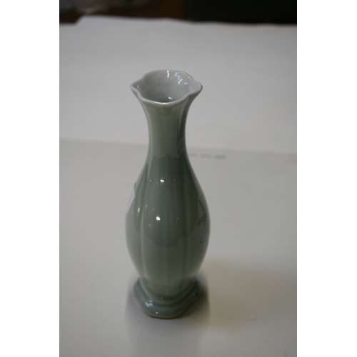 381 - A Chinese pale celadon glazed vase with blue seal mark to the underside, 20cms (8ins) high.