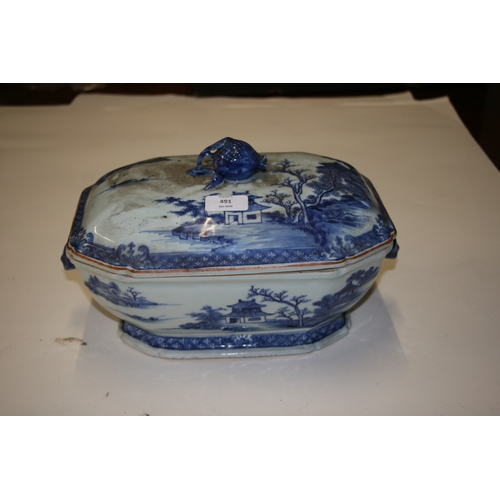 491 - An 18th century blue & white tureen and cover decorated with a landscape scene with hare's head hand... 