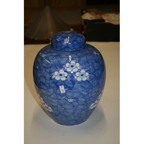 548 - A large Oriental ginger jar decorated with prunus on a cracked ice ground, 28cms (11ins) high.