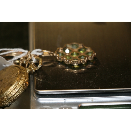 1012 - A 9ct gold peridot and seed pearl pendant; together with a 9ct gold chain; an open faced fob watch a... 