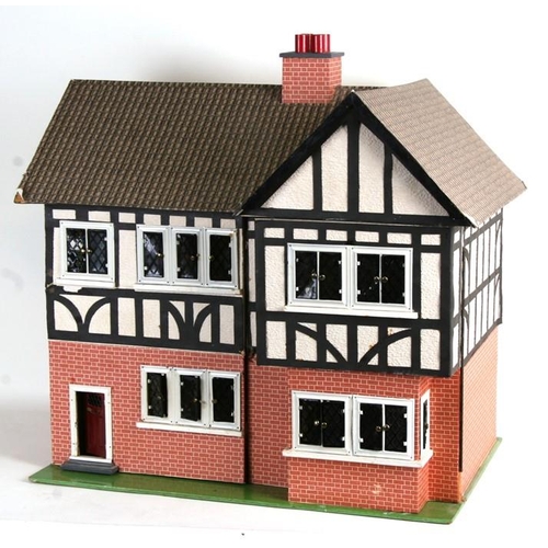 147 - A 1930's Tri-Ang mock Tudor two storey dolls house. together with some furniture and accessories 67c... 