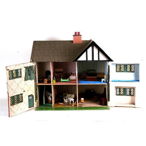 147 - A 1930's Tri-Ang mock Tudor two storey dolls house. together with some furniture and accessories 67c... 