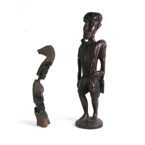 151 - An African carved hardwood figure, 55cms (21.5ins) high; together with another similar, 40cms (15.75... 