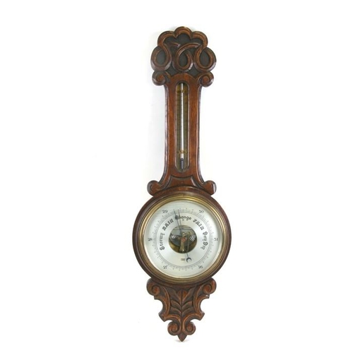 165 - An early 20th century oak cased barometer thermometer by Gamage of London, 79cms (31ins) high.