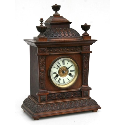 189 - An Edwardian Gothic style oak mantle clock, the white enamel dial with Roman numerals and fitted wit... 