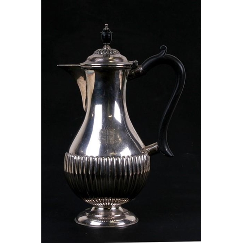 206 - A George VI silver water jug of baluster form in the 18th century style, with reeded body and turned... 