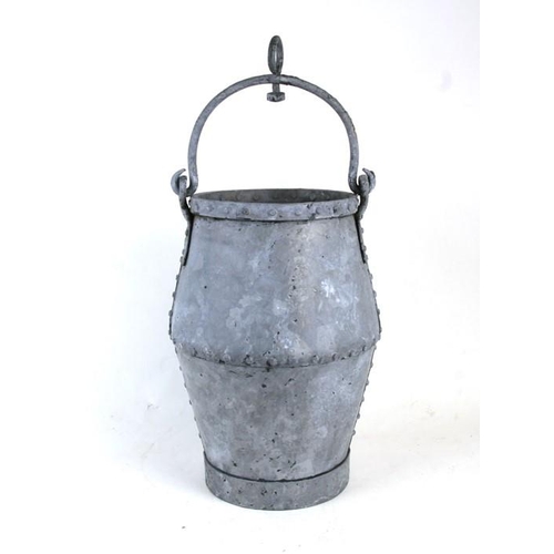 21 - A galvanised and riveted well bucket, 40cms (15.75ins) high excluding handle.