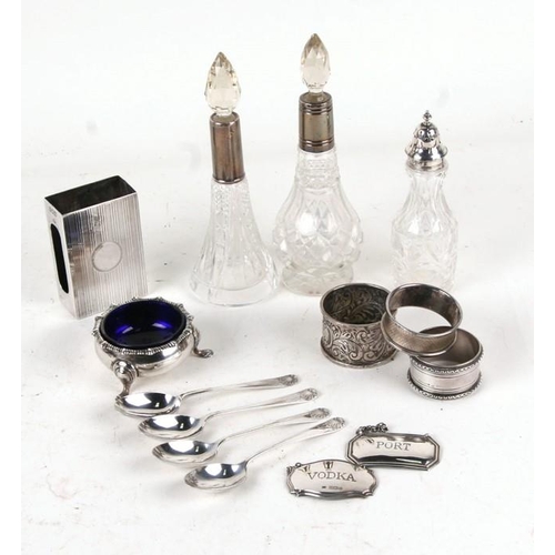 217 - A quantity of silver and silver mounted items to include salts, scent bottles and napkin rings.