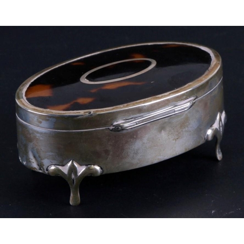 221 - A silver and tortoiseshell oval dressing table box, Birmingham 1923, 10cms (4ins) wide.