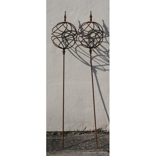 28 - A pair of wrought iron obelisks, 165cms (65ins) high.