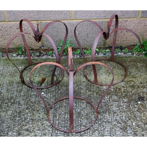 31 - Three wrought iron strap work crown garden planters, each 41cms (16 ins) high.