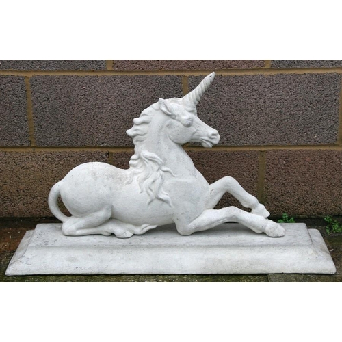 34 - A concrete unicorn on a plinth base, 88cms (33ins) wide.