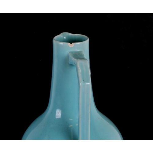 76 - A Christopher Dresser design turquoise glaze jug, 27cms (10.25ins) high.Condition Report Crazing to ... 