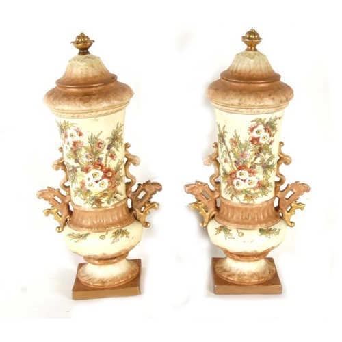 77 - A pair of Victorian blush ivory vases and covers, decorated with a spray of flowers, 32cms (12.5ins)... 