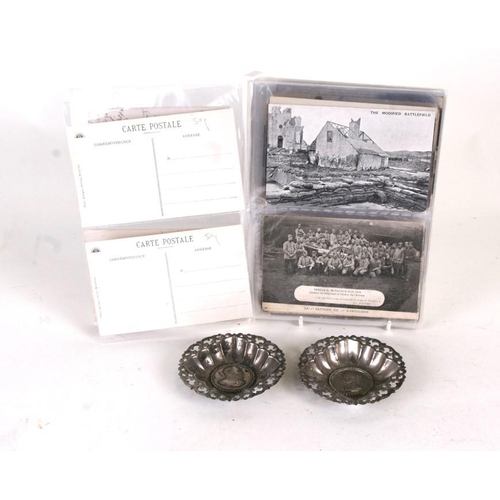 97 - A quantity of assorted WWI postcards to include tanks, battle scenes and two pin trays.