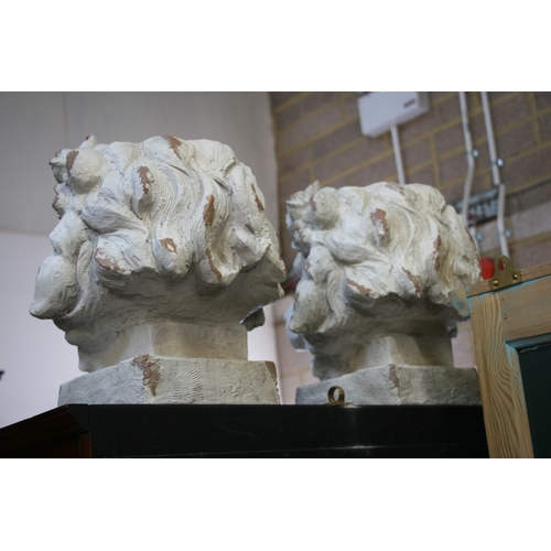 30 - A pair of distressed painted urns in the form of lion heads, each 43cms (17ins) high (2).