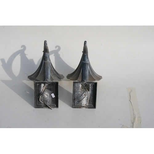 37 - A pair of patinated metal outside wall lights, 38cms (15ins) high.