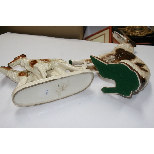 52 - A quantity of porcelain Borzoi figures and similar items, the largest 33cms (13ins) high.