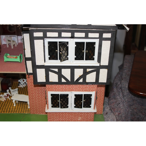 147 - A 1930's Tri-Ang mock Tudor two storey dolls house. together with some furniture and accessories 67c... 