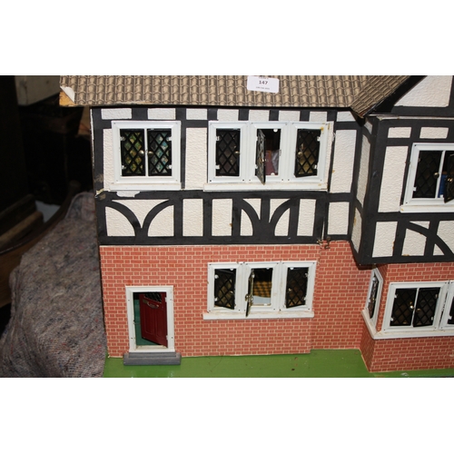 147 - A 1930's Tri-Ang mock Tudor two storey dolls house. together with some furniture and accessories 67c... 