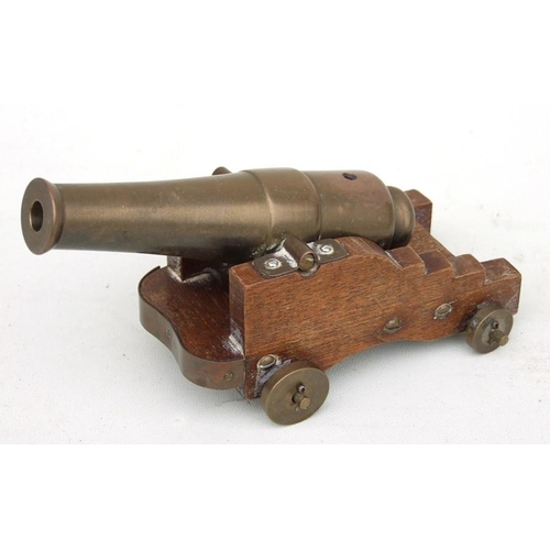 109 - A late 19th century signal cannon with a bronze barrel mounted on a wooden carriage with bronze whee... 